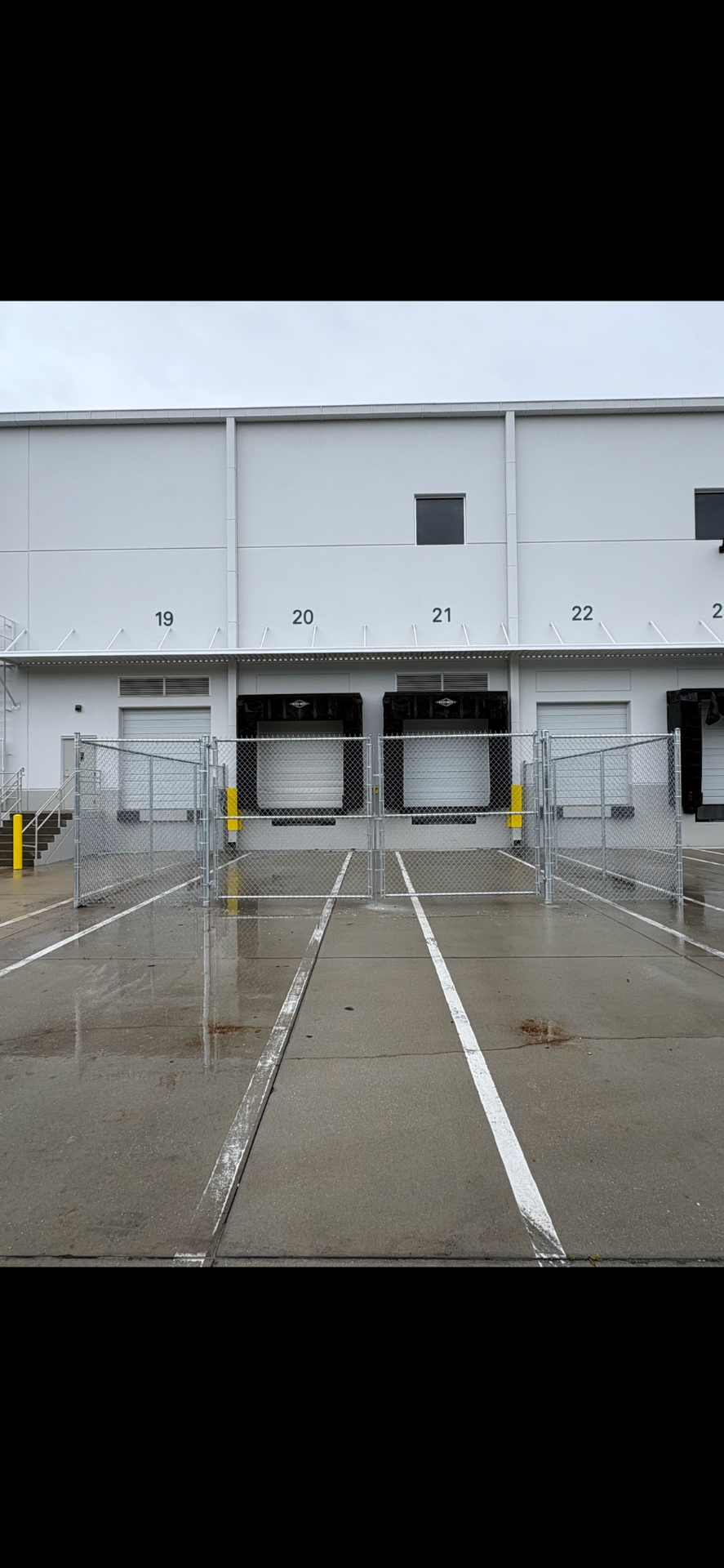 Commercial chain link gate installation at loading dock